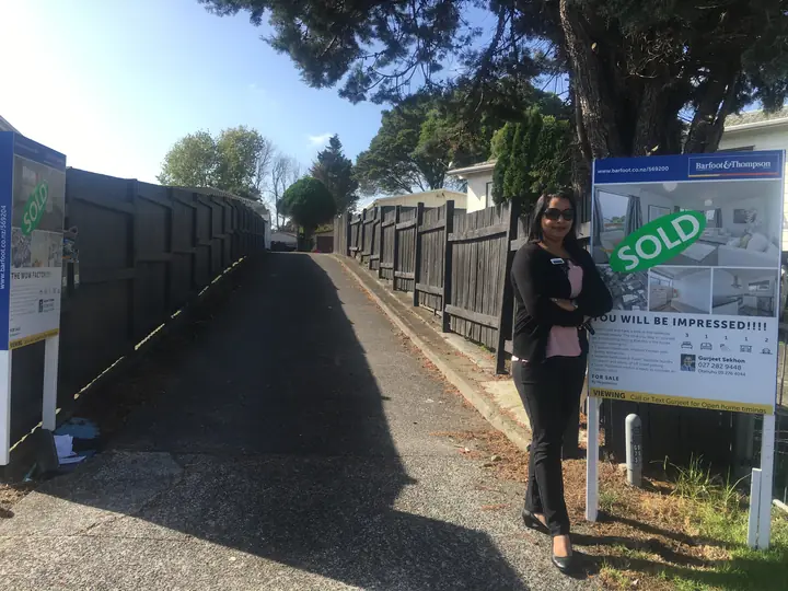 Two SOLD signs on one driveway: “You will be impressed!!!!” and “The Wow Factor!!!”